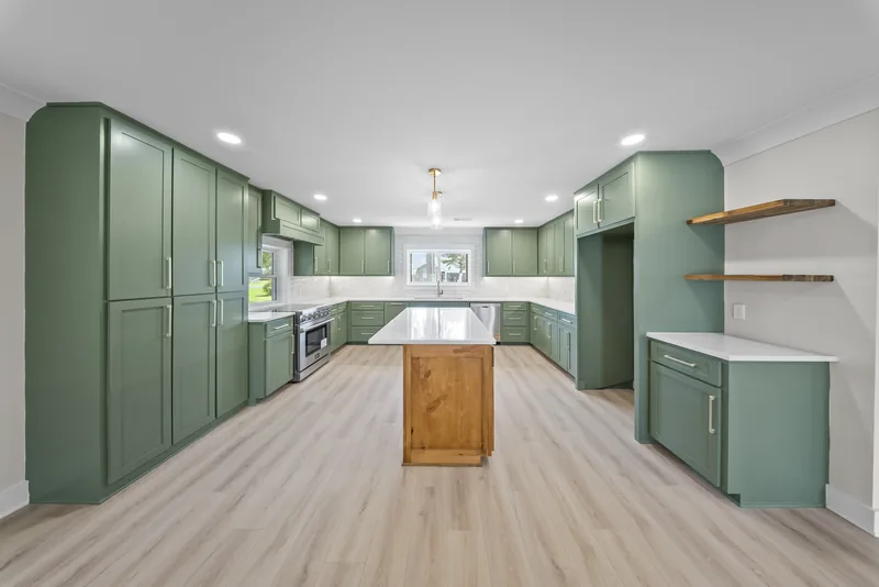 Completed kitchen showing coordinated cabinetry, counters, and flooring